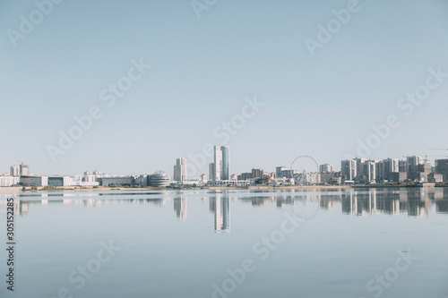  Silhouette of a modern city. Day panorama of Kazan and the river.