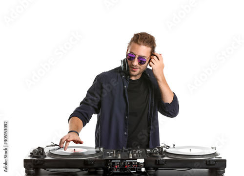 Male dj playing music on white background photo
