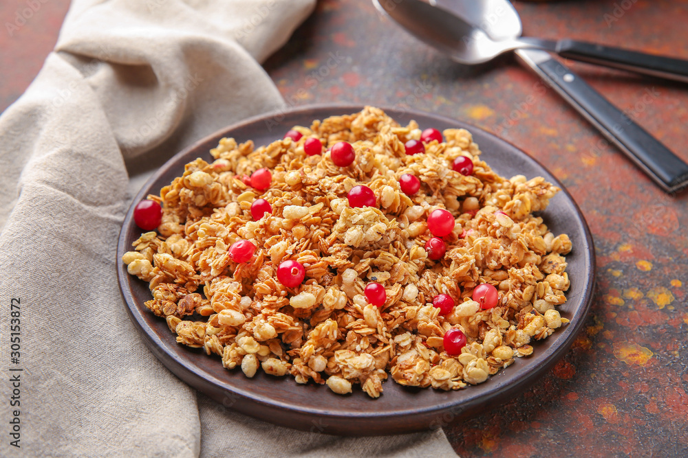 Plate with tasty granola and berries on table Plate with tasty granola and berries on table