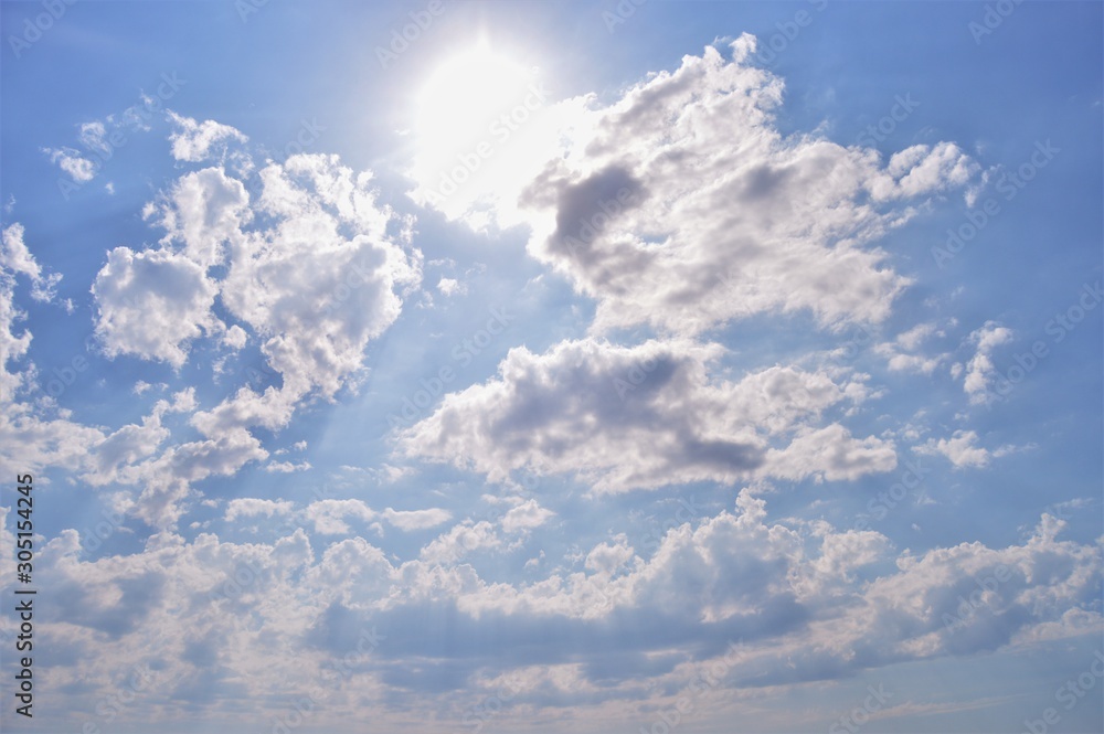 bright blue sky with clouds in the sunlight. bright blue sky with clouds in the sunlight.