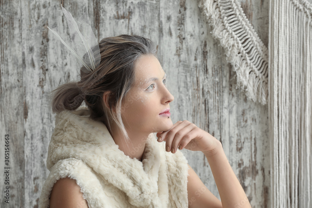 Naklejka premium Beautiful woman with creative makeup on light background