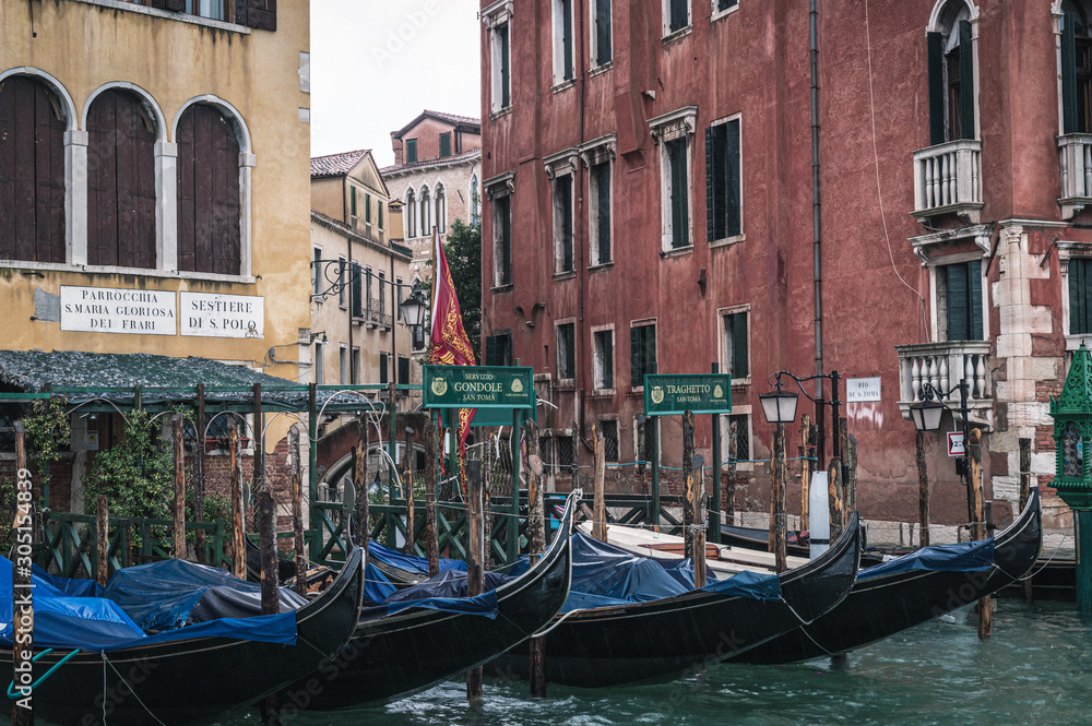Venice, Veneto, Italy - 15.11.2019, View of gondolas and typical Venetian houses and architecture. Beautiful and romantic Italian city on water. 