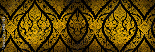 Fototapeta Closeup Thai pattern carving lotus picture at door in temple
