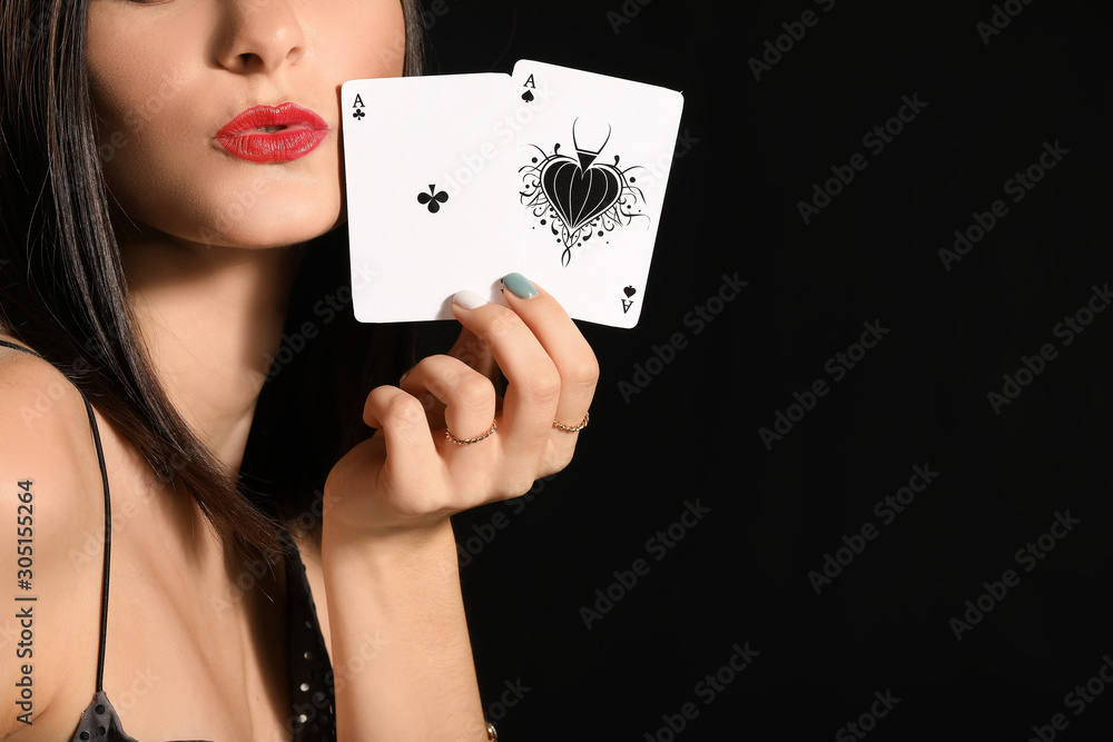 Beautiful young woman with playing cards on dark background, closeup Beautiful young woman with playing cards on dark background, closeup