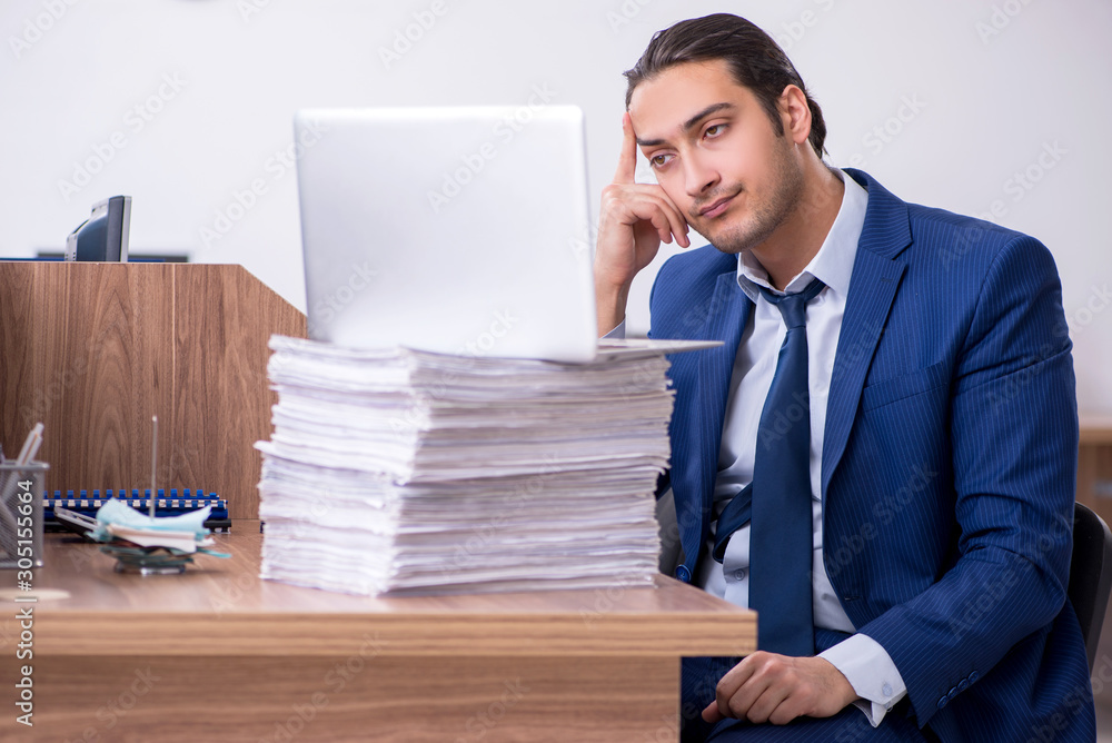 Young handsome businessman working in the office