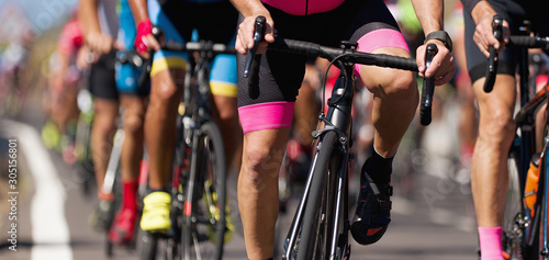 Cuadro en lienzo Cycling competition, cyclist athletes riding a race, climbing up a hill on a bic