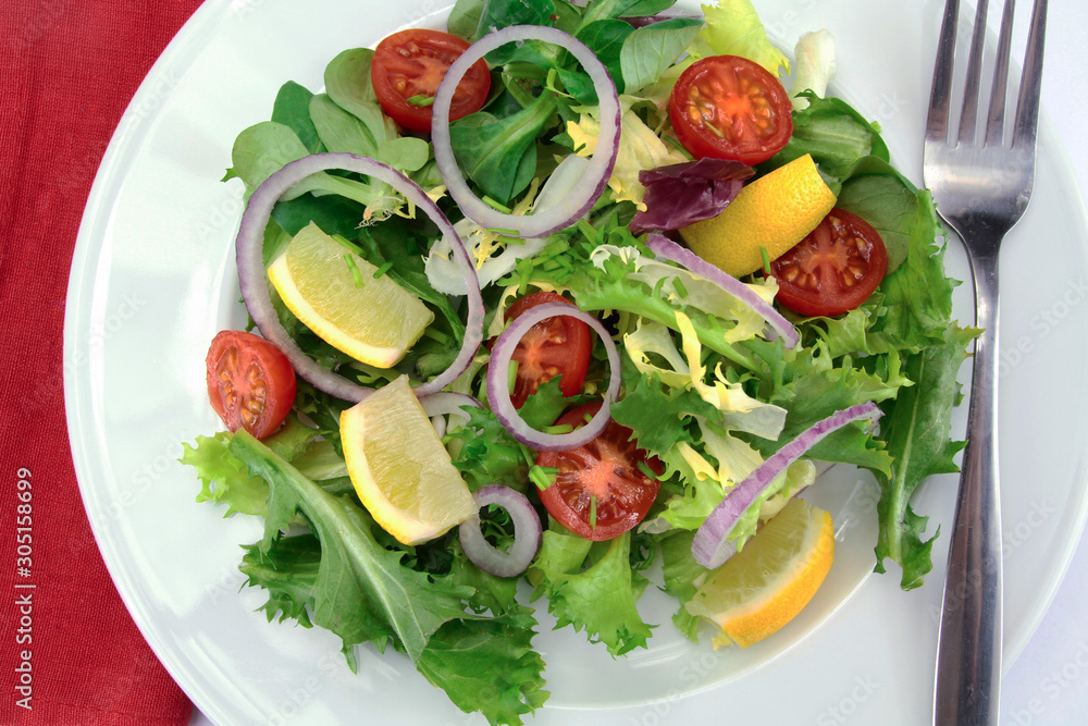 salad and raw vegetables on a plate salad and raw vegetables on a plate