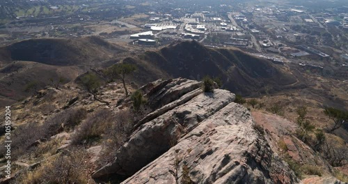 Slow pan upward toward the sun on top a mountain near downtown Salt Lake City