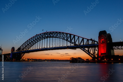 Illuminated Sydney Harbour Bridge viewed from Kirribilli at sunset photo