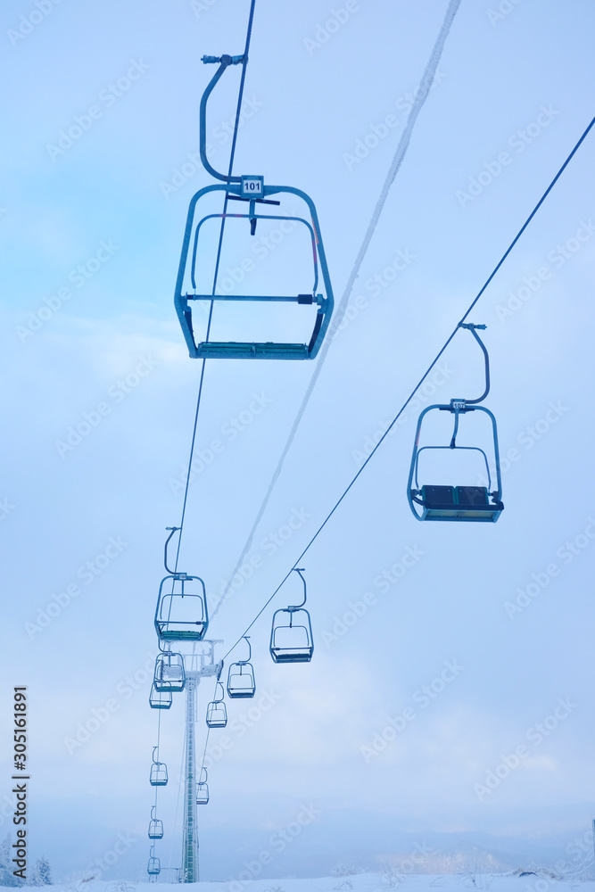 Funicular for tourists, skiers and snowboarders. lift to transport people in the mountains. the cable car on the background of blue mountains. Funicular for tourists, skiers and snowboarders. lift to transport people in the mountains. the cable car on the background of blue mountains.