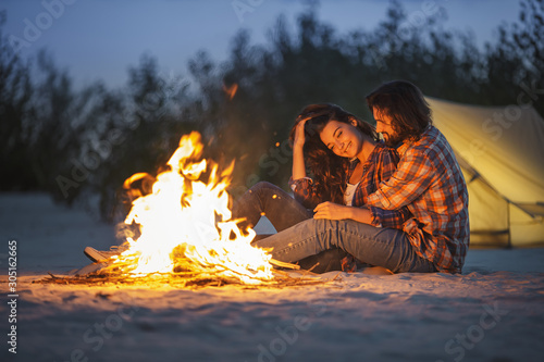 Couple Camping Near Campfire