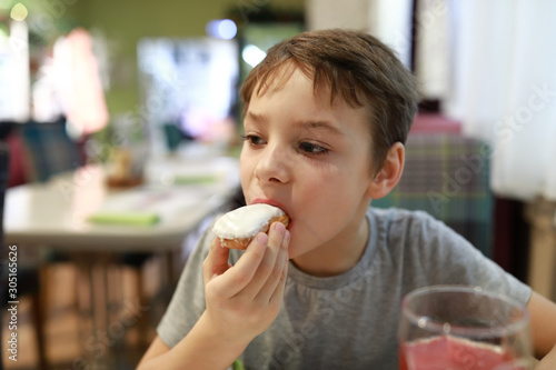 Boy eating vanilla eclair