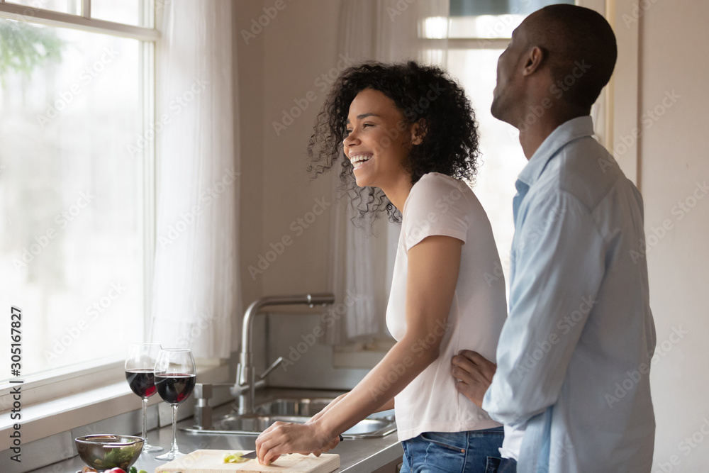 Smiling biracial couple have fun enjoying domestic date Smiling biracial couple have fun enjoying domestic date