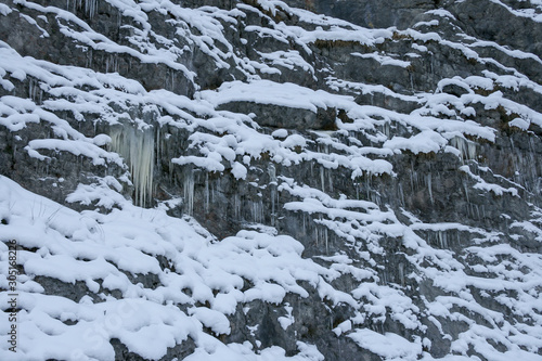 A lot of icicles have been formed due to the water rushing down the mountains and then freezing while falling down a cliff.