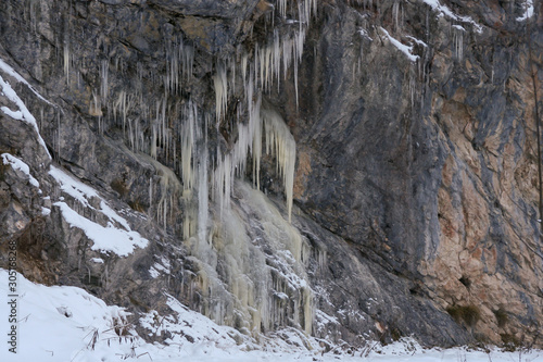 A lot of icicles have been formed due to the water rushing down the mountains and then freezing while falling down a cliff.