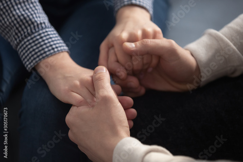 Close up of loving couple hold hands showing love © fizkes