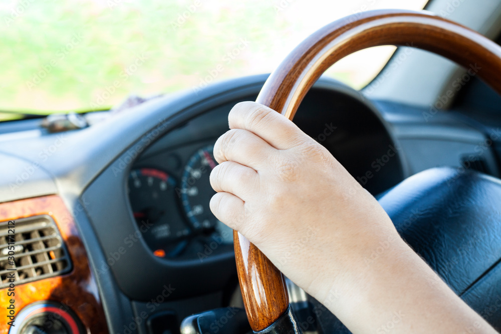 Hands on the steering wheel. Right-hand drive car.