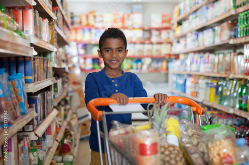 boy with cart in shop