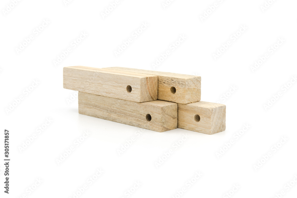 4 long strips of perforated wooden blocks neatly stacked together isolated on white background 4 long strips of perforated wooden blocks neatly stacked together isolated on white background