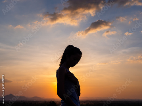 Free young woman at golden sunset. Freedom and success concept,relaxing and enjoying nature with copy space.