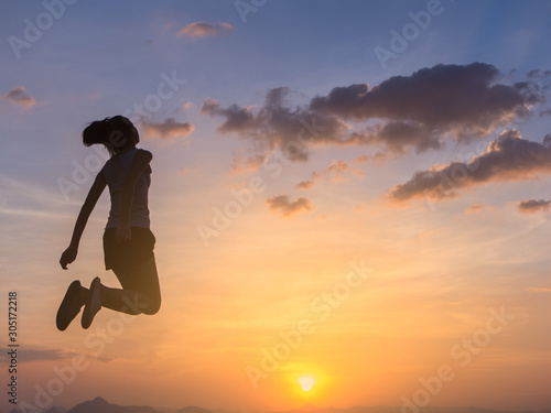 cheering happy young asian woman jumping and having fun. happiness and freedom concept for people enjoy the outdoor.