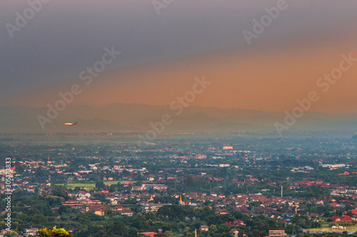 The blurred background of the twilight light in the evening under the trees, surrounded by mountains and cool breeze, seen during the tourist spots. © bangprik