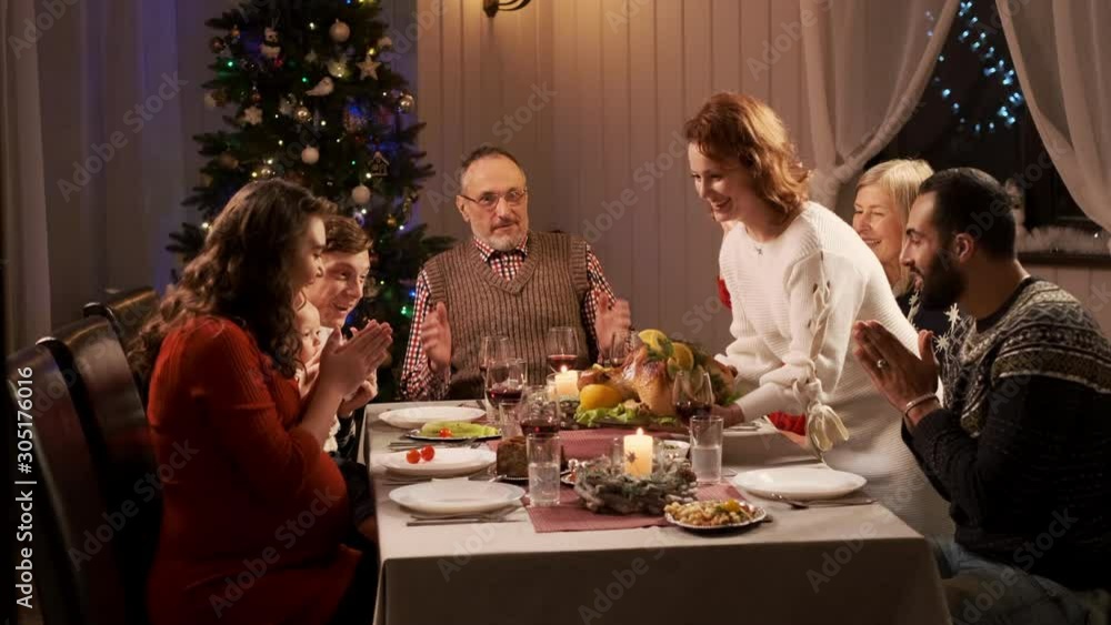 New Year. Served Holiday Table. Woman Serves Chicken Main Dish. New Year. Served Holiday Table. Woman Serves Chicken Main Dish.