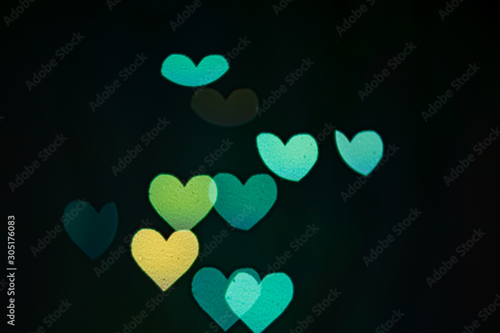 blue hearts bokeh on black background
