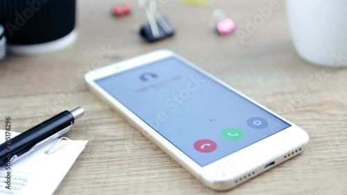 Call on mobile phone lying on desk in office