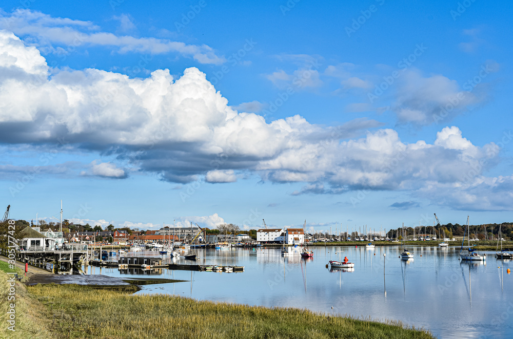 Woodbridge harbour with boats sitting in the river