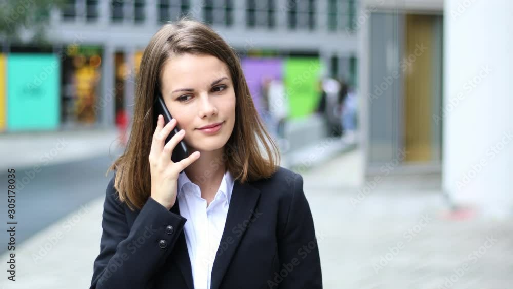 Portrait of a young woman walking and talking on the phone Portrait of a young woman walking and talking on the phone