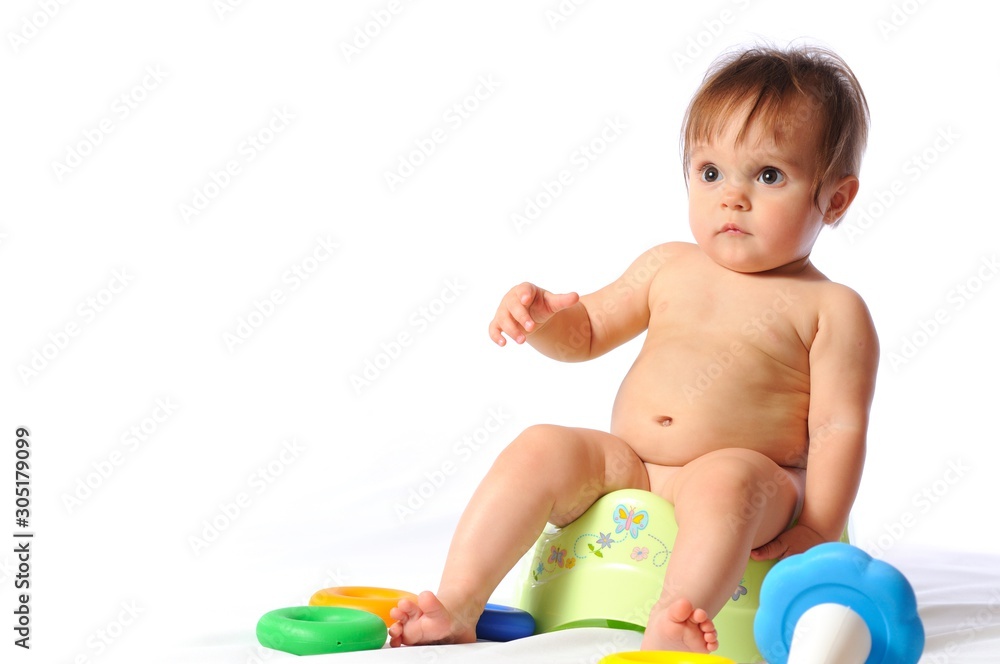Baby sits on potty and plays toy Baby sits on potty and plays toy