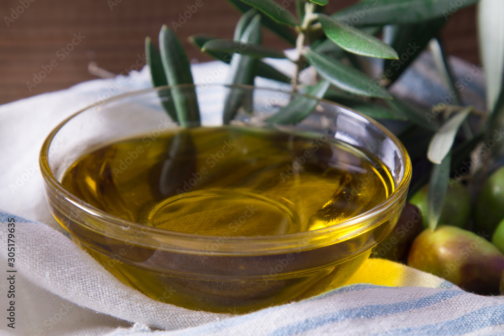 glass vessel with extra virgin olive oil and olives with branch glass vessel with extra virgin olive oil and olives with branch