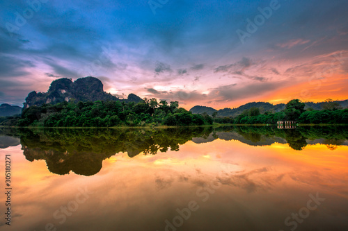 Blurred panoramic nature background on the large lake, reflected by the water of trees, the atmosphere is surrounded by big mountains