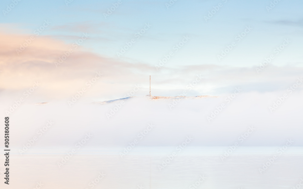 Kirkenes See Mist. A sea mist shrouds the Kirkenes coastline. Kirkenes is a town located in Northern Norway close to the Russian border.