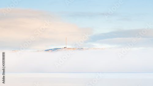 Kirkenes See Mist. A sea mist shrouds the Kirkenes coastline. Kirkenes is a town located in Northern Norway close to the Russian border.