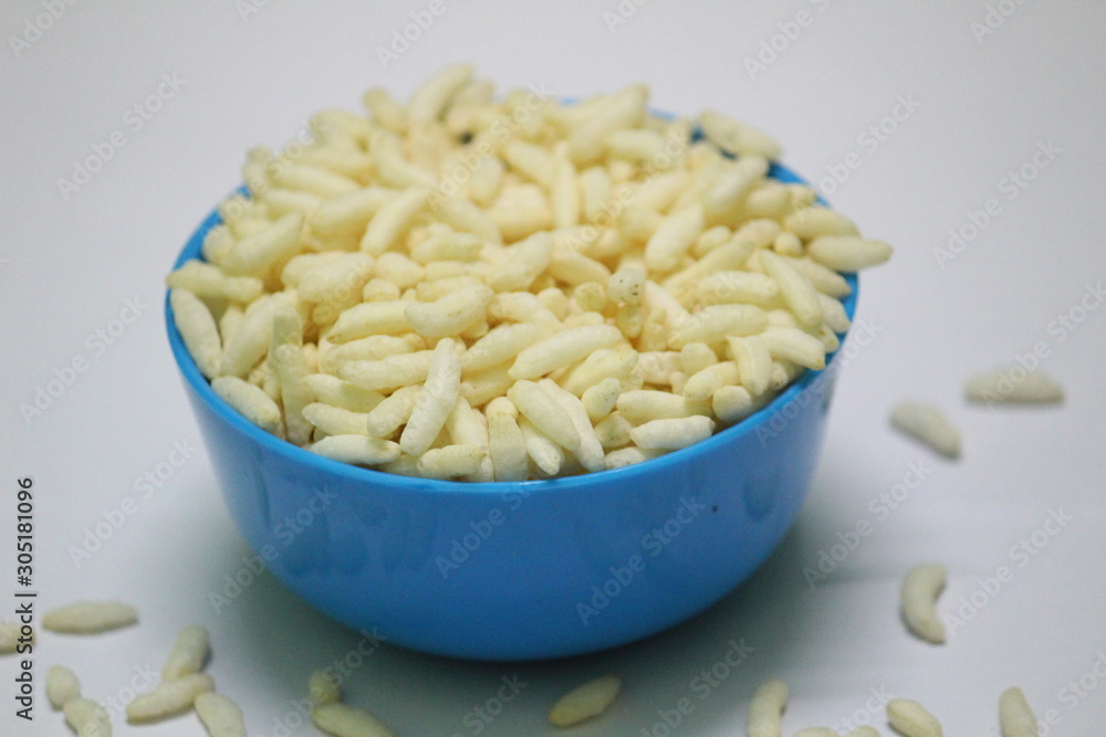 Puffed rice on the blue bowl with white background Puffed rice on the blue bowl with white background