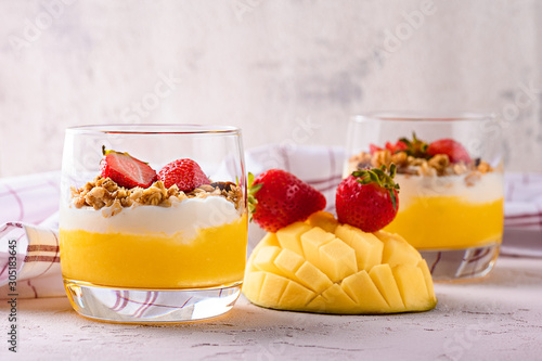 cream cheese with mango, baked oatmeal and strawberries on pink background photo