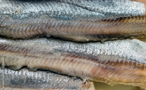 close up of herring fillet in oil.