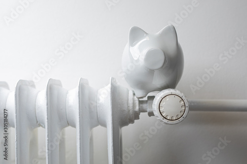 Photos heater money pig on white wall