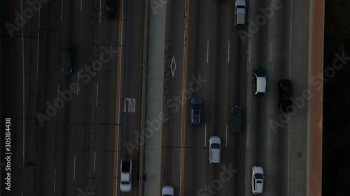 Aerial bird's eye pulling out from tight to wide of rush hour traffic patterns on the freeway in West Los Angeles. 4K photo