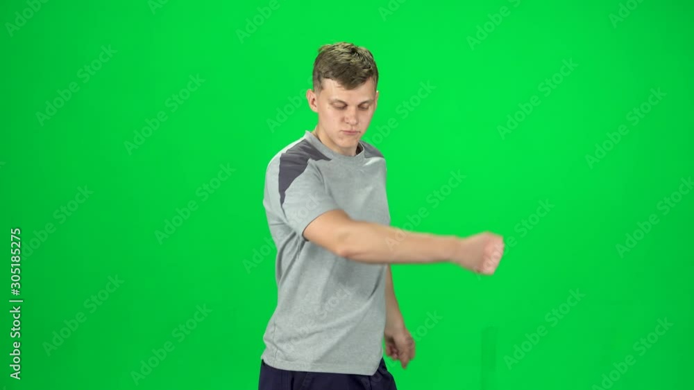 Guy goes and dances, smiles and rejoices on a green screen, Chroma Key. Side view Guy goes and dances, smiles and rejoices on a green screen, Chroma Key. Side view