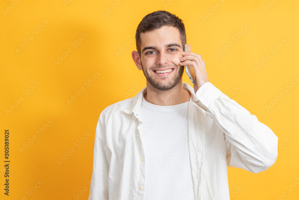 portrait of young man with mobile phone on color background portrait of young man with mobile phone on color background