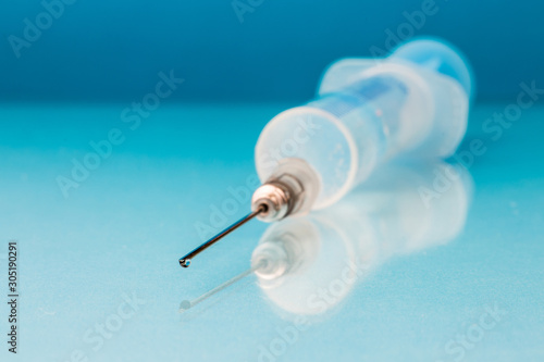 Syringe on the table close up in blur