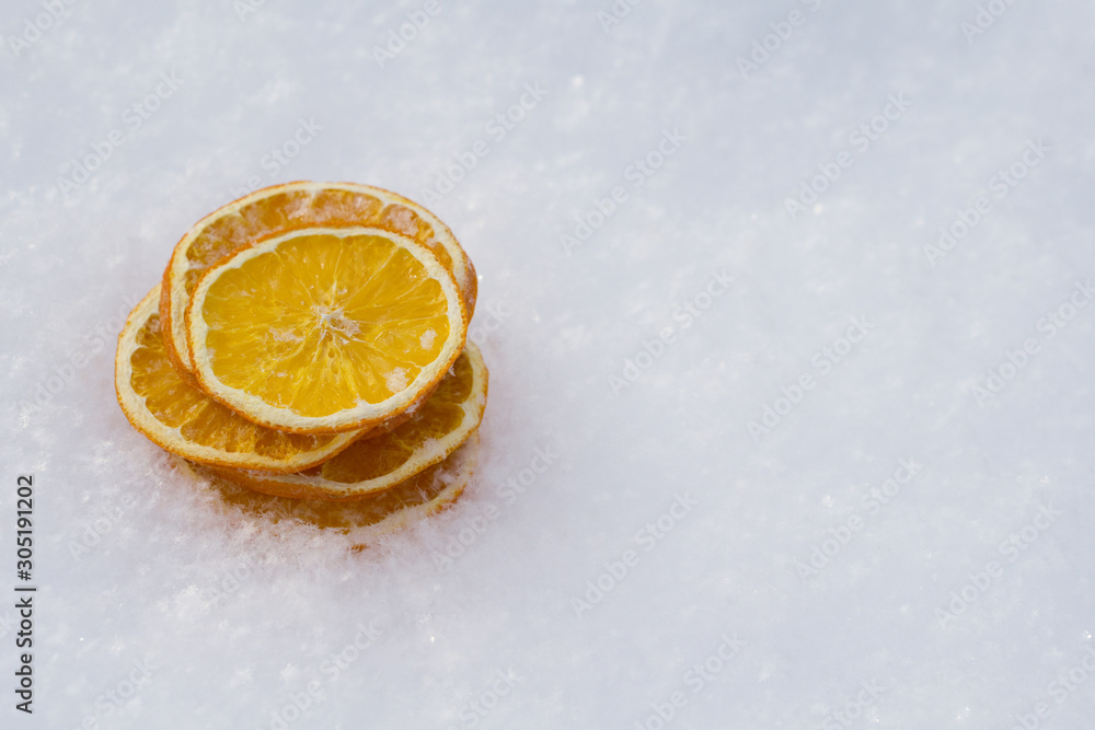 Merry Christmas and New Year greeting card with dry orange, Clementines tangerines on snow Merry Christmas and New Year greeting card with dry orange, Clementines tangerines on snow