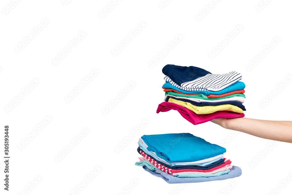 Hand with stack of clothes, fresh laundry textile. Isolated. Hand with stack of clothes, fresh laundry textile. Isolated.