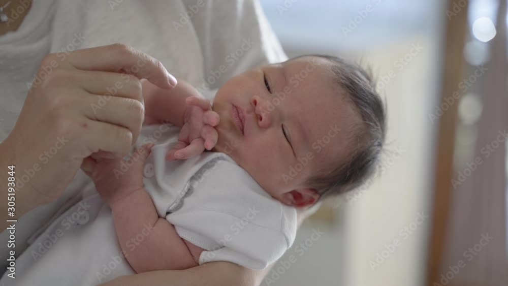 Close up loving mother kissing baby daughter in the house