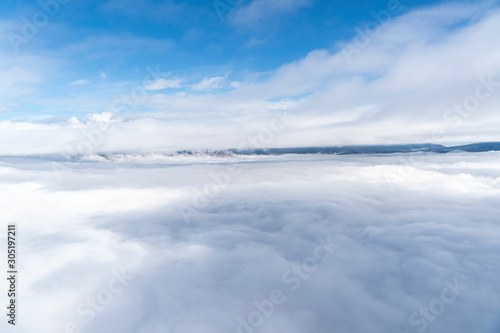 views of the mountains  clouds and fog below during a hot air balloon flight in La Cerdanya  Catalonia