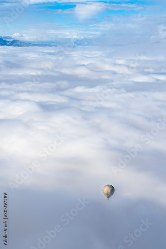 hot balloon between clouds in the area of Cerdanya, in Catalonia