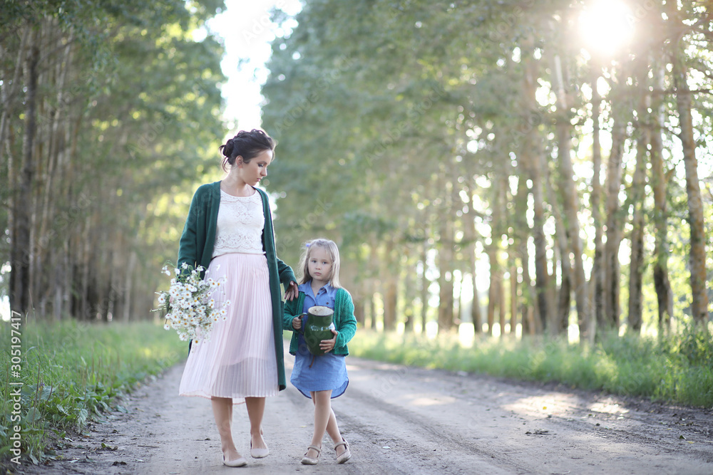 Mother with daughter walking on a road Mother with daughter walking on a road